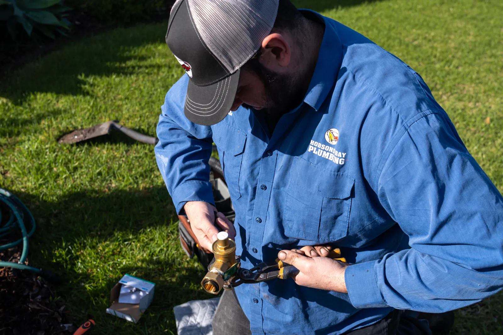 Gas fitter repairing gas pipework in Flemington