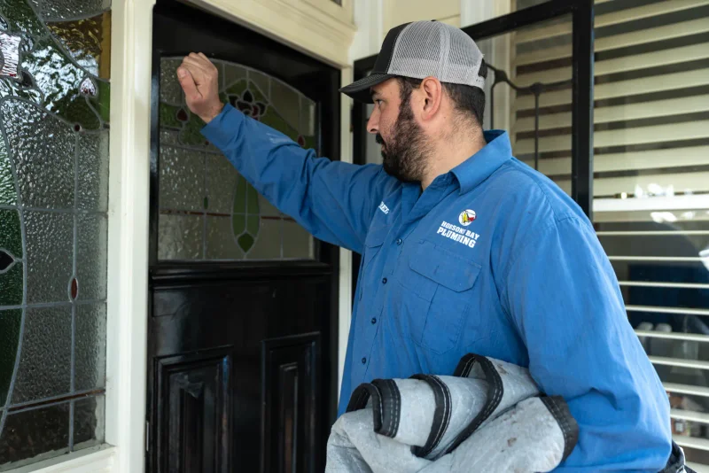 Hobsons Bay plumber at a customer's front door after finishing the job