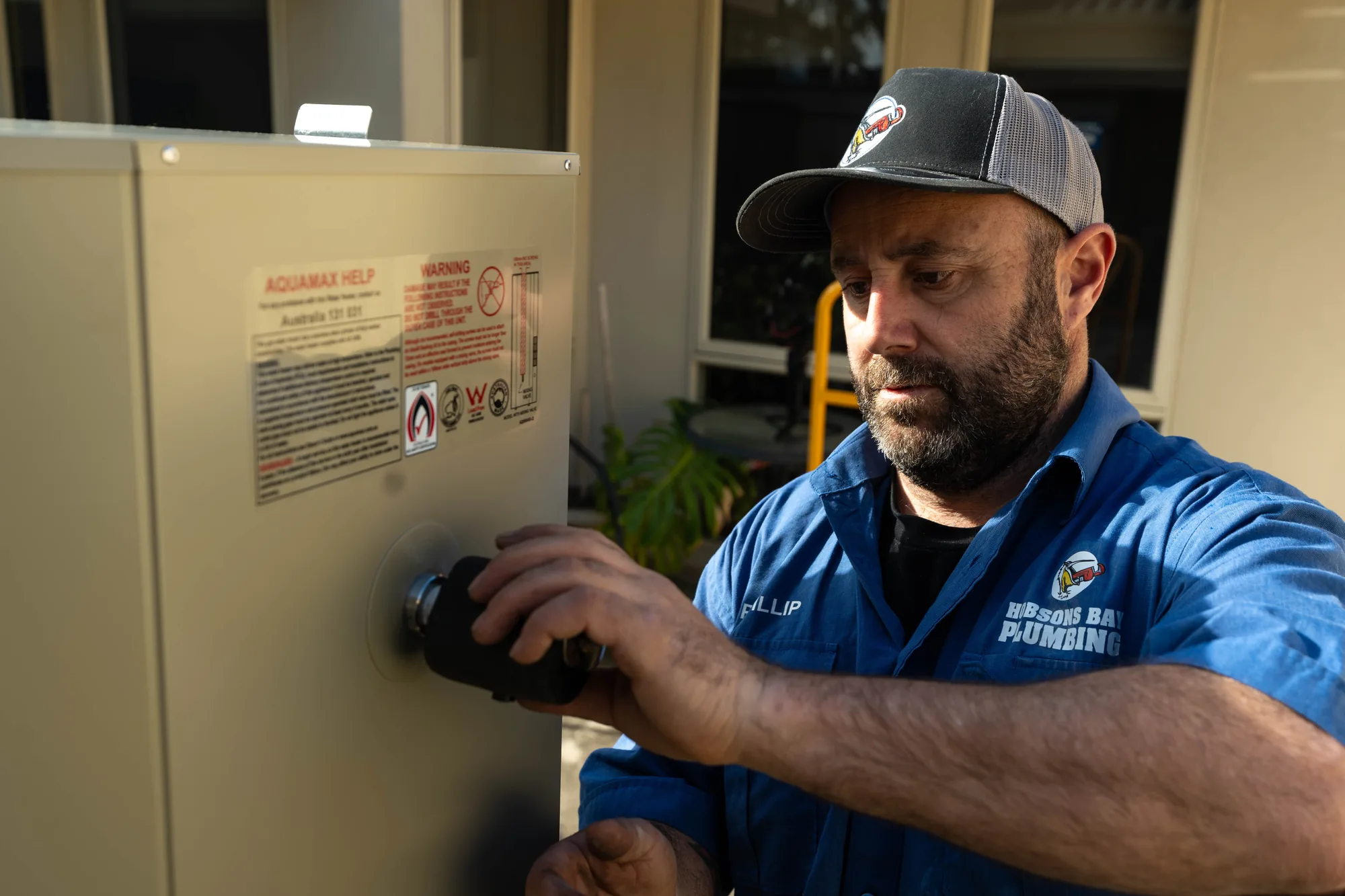 Plumber servicing a hot water system in Albert Park