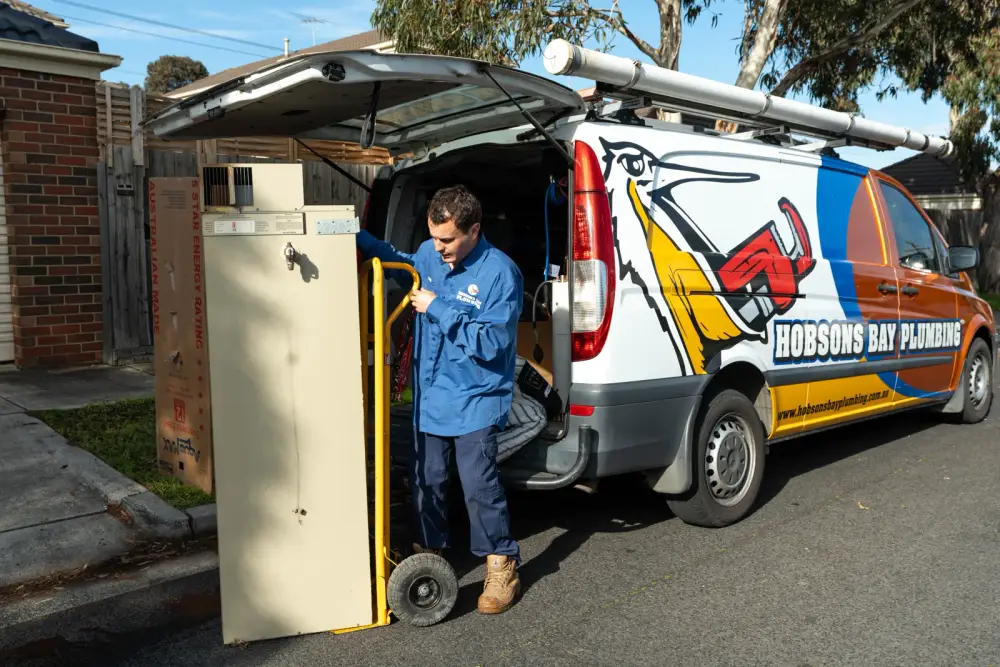 Daniel unloading a new hot water system from the Hobsons Bay Plumbing van