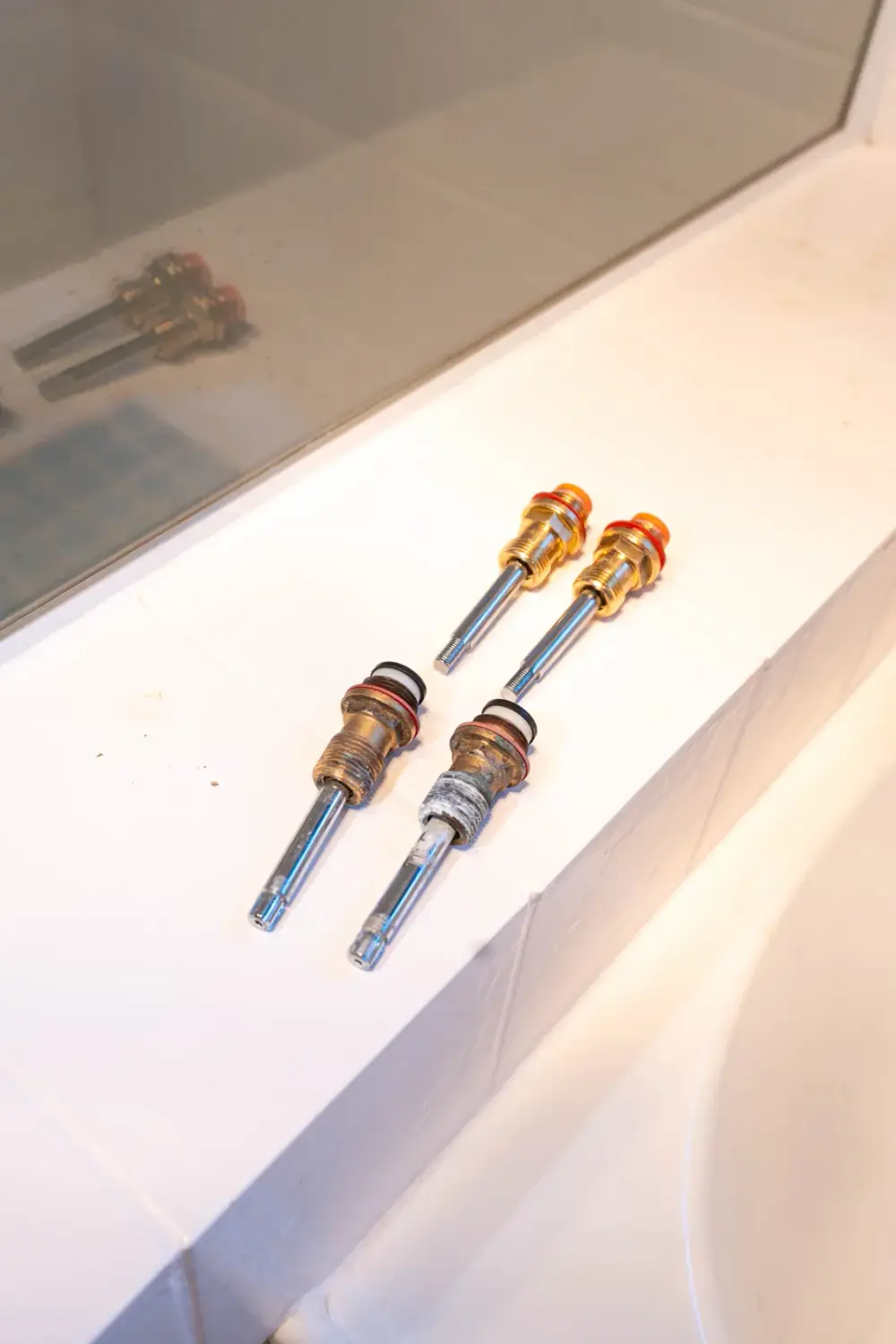 Plumber replacing tap cartridges during a leak repair