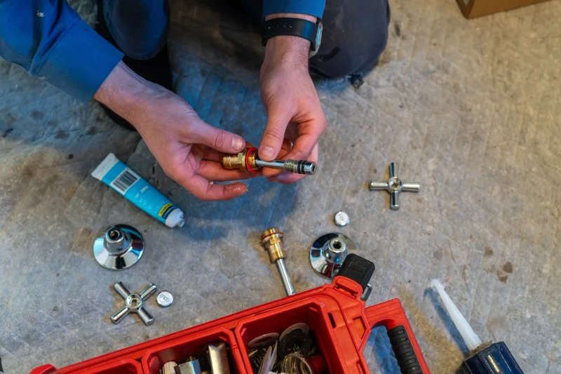 Tap service parts laid out before a leaking tap repair in Newport