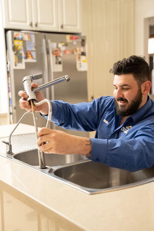 Licensed plumber servicing kitchen taps and plumbing in Altona